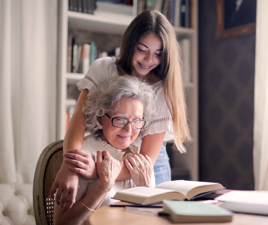 girl with her grandma, happy reading a book